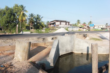 The culvert that was constructed at Belladrum by Kares Construction, which residents yesterday said deserved an “F-Grade” for the poor work done since it caused the sinking of the public road, which is now visibly uneven in a number of areas. (Photo by Arian Browne) 