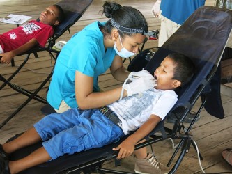 Dr Sulan Fung works on a patient during the outreach at Santa Mission