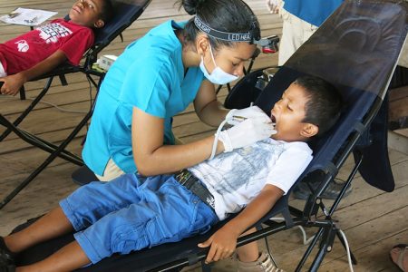 Dr Sulan Fung works on a patient during the outreach at Santa Mission
