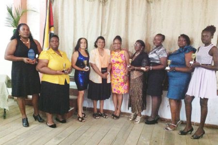 Recipients of the GNA awards, from left, Michelle Lewis, Ruth Hinds, Dawn Dunn, and Rhonda Mingo, Shaunette Waterman, Cedina Forde and Renee Hutson flank Chief Nursing Officer Tarramattie Barker and GNA President Joan Stewart (fourth and fifth from left) as they display their tokens.
