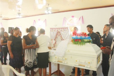 In this Arian Browne photo relatives and friends pay their final respects.