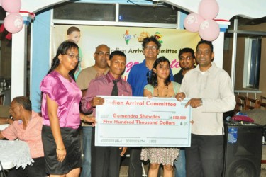 Members of the Indian Arrival Committee (IAC) presented Guyana’s youngest ever world champion, power lifter Gumendra Shewdas with a $500,000 cheque Saturday night in honour of his historic achievement at the World Sub Juniors and Juniors Championships in Killeen, Texas. (Orlando Charles photo) 