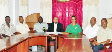 President of the GOA, K Juman-Yassin poses for a photo opportunity with officials of the team for the inaugural South American Youth Games. (Orlando Charles photo) 