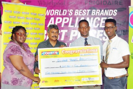 GLTA Vice President Grace McCalman (left) and GLTA President Ramesh Seebarran (second left) collect the sponsorship cheque from Courts Marketing Manager Pernell Cummings (right) and Courts Public Relations Officer (PRO) Kester Abrams.