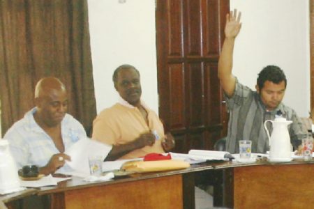 Douglas Gittens raises his hand to make a contribution during the September statutory meeting of the Regional Democratic Council, Region Ten, last Thursday. Also in picture are RDC Councillors Audwin Rutherford (left) and Leslie Gonsalves