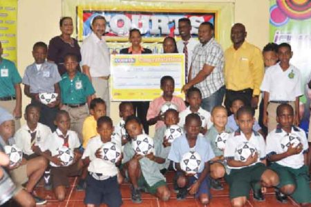 Managing Director of Courts Guyana Incorporated Clyde de Haas handing over sponsorship cheque to Petra Organization Co-Director Troy Mendonca as fellow executives and students from the participating schools look on.
