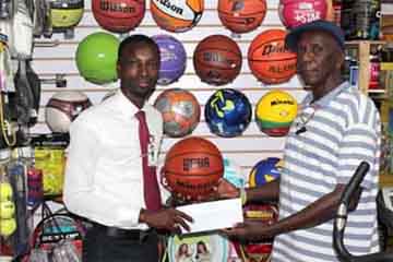TGH Chairman Dennis Clarke (right) receiving the sponsorship cheque from Giftland Office Max PRO Compton Bobb 