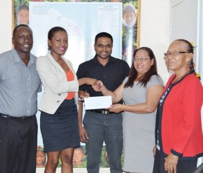 Telephone Company, Digicel yesterday presented a cheque to Minister of Amerindian Affairs Pauline Sukhai to continue its trend of supporting Amerindian Heritage month’s sports events.  Digicel’s Public Relations Manager Shonnet Moore (second from left) handing over the cheque to Minister of Amerindian Affairs Pauline Sukhai. At centre is Permanent Secretary of the Ministry of Amerindian Affairs Nigel Dharamlall, while to the Minister’s left is Liaison to the Ministry, Yvonne Pearson. To Moore’s right is Digicel’s Event and Sponsorship Manager, Gavin Hope. (GINA photo)