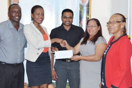 Telephone Company, Digicel yesterday presented a cheque to Minister of Amerindian Affairs Pauline Sukhai to continue its trend of supporting Amerindian Heritage month’s sports events.
Digicel’s Public Relations Manager Shonnet Moore (second from left) handing over the cheque to Minister of Amerindian Affairs Pauline Sukhai. At centre is Permanent Secretary of the Ministry of Amerindian Affairs Nigel Dharamlall, while to the Minister’s left is Liaison to the Ministry, Yvonne Pearson. To Moore’s right is Digicel’s Event and Sponsorship Manager, Gavin Hope. (GINA photo)