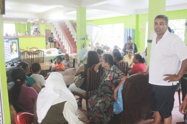 In this photo CIOG executive Gulzar Namdar stands with the gathering as they view Zulfikar’s death announcement on TV. 