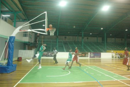 Lodge-Meadowbrook’s Shawn Blair (in green) scoring an easy basket against Buxton in their group ‘C’ fixture.