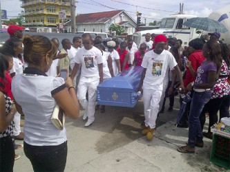 Pall bearers carry the body of murdered biker Kirk Davis yesterday