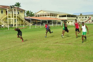 Kevin Abbensetts (left) dips ahead of Tevin Garraway (right) as he hops across the finish line in agony yesterday afternoon at the Eve Leary ground at the Inter-Guiana Games (IGG) trial (Photo by Orlando Charles).