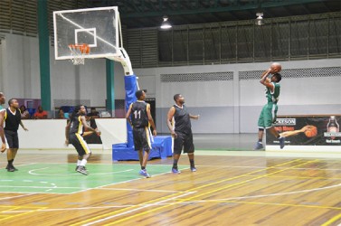 A Tucville/Guyhoc player attempting a shot against East/West Ruimveldt side Sunday night at the Cliff Anderson Sports Hall in the Inter-Ward encounter.    