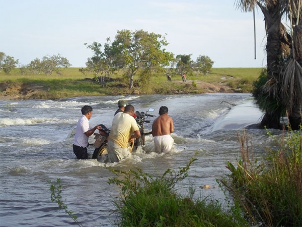 Not bikers fest: Heavy rains in the South Rupununi a few weeks ago saw creeks and streams overflowing their banks and bridges being covered leaving travelers stranded unless they decided to lift their motorbikes over the raging waters as in this case on the road heading to Karaudarnau. 