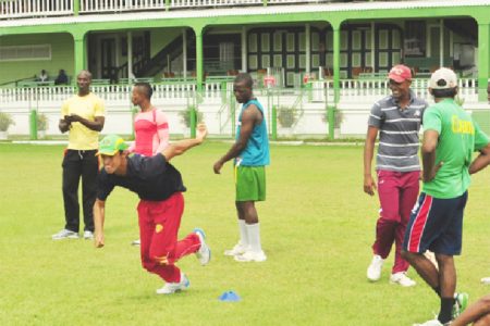 Young batting sensation and son of West Indies test batting legend Tagenarine Chanderpaul does  his fitness drills watched closely by national selector Rayon Griffith at left. (Orlando Charles photo)