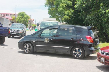 The taxi that police used to pursue two of the fleeing bandits. During an exchange of gunfire, several bullets struck its windscreen. In this Arian Browne photo, the damaged car is being towed away by police.