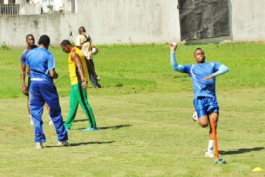 Left-arm bowler Andre Stoll bangs one in at the solitary stump while right-arm fast bowler Kellon Carmichael gathers some pace during training. 