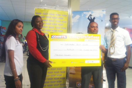 David Mohammed, Vice-President of the Lusignan Golf Club, receives the cheque for $250,000 from Courts Customer Experience Manager Shondell Bacchus yesterday afternoon in the presence of Kester Abrams, Courts Marketing Officer of Public Relations and Promotions and Joaan Deo.
