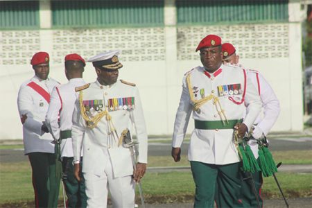 Rear Admiral (rtd) Gary Best (left) and Chief-of-Staff of the Guyana Defence Force Brigadier Mark Phillips walk to the podium for the final inspection of the parade on Tuesday. (Photo by Arian Browne)