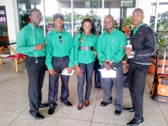 Reigning Mr. Guyana, Kerwin Clarke (extreme right) as well as Devon Davis (second from left) and Alisha Fortune pose with president of the GABBFF, Keavon Bess (extreme left) and Mervyn ‘Spongy’ Moses before departing yesterday for the Dominican Republic to compete in the 41st CAC Bodybuilding and Fitness Championships.