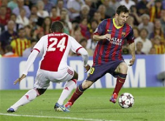 Barcelona’s Lionel Messi (R) evades Ajax’s Stefano Denswil (L) before scoring his second goal during their Champions League football match at Camp Nou stadium in Barcelona yesterday.Credit: Reuters/Gustau Nacarino