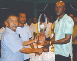 GFSCA organiser Wayne Jones (right) receiving tournament trophies from Ramchand Ragbeer.