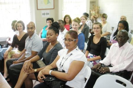 New volunteers attached to Cuso Guyana sit among its representatives and other partners. 