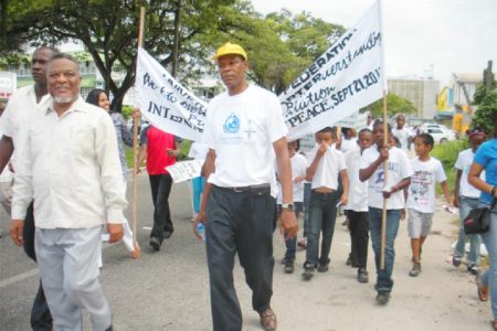 Prime Minister Samuel Hinds joined children and members of the Universal Peace Federation on Main Street in their march for World Peace Day yesterday. (Photo by Arian Browne)