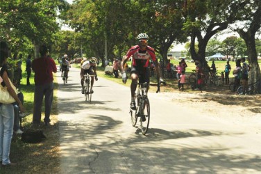 Yesterday’s top performer, Michael Anthony crossing the finish line in the feature 35-lap event of the second annual RRT Enterprise 11-race programme at the National Park. (Orlando Charles photo) 