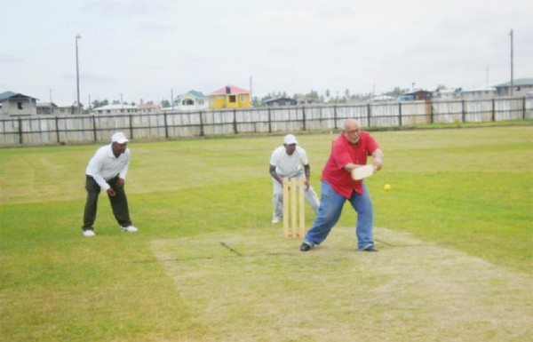 President Donald Ramotar hits the opening ball of a game at the Enmore Community Centre Ground for four.  