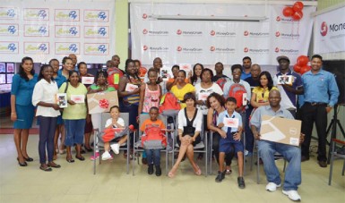 Winners in MoneyGram’s ‘Back to School Promotion’ display their prizes.  