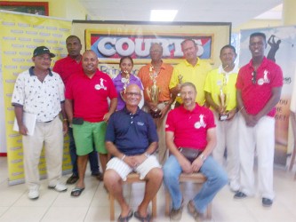 Maurice Solomon (fourth right standing ) with other winners while Courts Managing Director Clyde DeHaas and Lusignan Golf Club President Jerome Khan  are sitting.