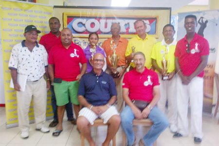 Maurice Solomon (fourth right standing ) with other winners while Courts Managing Director Clyde DeHaas and Lusignan Golf Club President Jerome Khan  are sitting.
