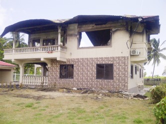 The gutted remains of Monica Chisholm’s house yesterday