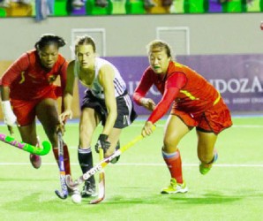 Argentina’s Carla Rebecchi (centre) battling Guyana’s Ulrica Sutherland (left) and Marzana Fiedtkou for possession of the ball during their team’s 22-0 defeat of Guyana on Tuesday at the PAHF Cup. (See story on page 26) 