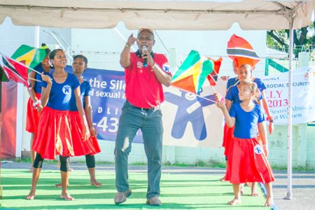 Reverend Charles of the Flaming World Ministry preformed a song calling for an end to child abuse, while engaging the Sophia Centre Dance Troupe on Wednesday at the National Park (Photo by Arian Browne)