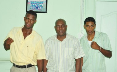 Ready for Almaty! Amateur pugilists, Dennis Thomas (left) and Imran Khan (right)  pose with GBA head, Steve Ninvalle following yesterday’s pep talk before winging out to Almaty, Kazakhstan to compete in the World Amateur Boxing Championships. (Orlando Charles photo) 