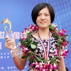 Chinese grandmaster Hou Yifan proudly displays her World Championship trophy after she defeated Anna Ushenina of the Ukraine by 5.5 points to 1.5 . Hou is a professional chess player and university student. Her prize money totalled US$160, 000 for the championship tournament. 