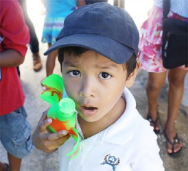 I made this: A child holds up his creation at the end of the summer class