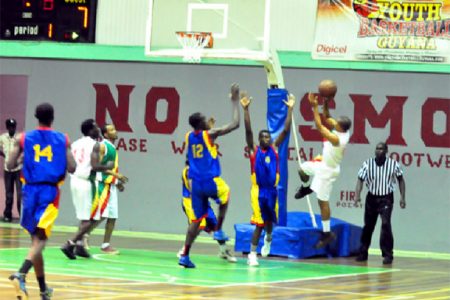 Albouystown/Charlestown’s Sheldon Thomas shooting over Werk-en-Rust/Wortmanville duo of Joslyn Crawford (number 12) and Michael Turner (number 8) in the first game of the best of three finals Friday night at the Cliff Anderson Sports Hall.
