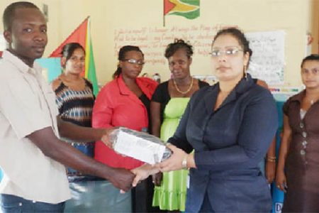 BBCI Administrative Assistant Bibi F Alli (second, right) handing over a television set, a DVD player and a voltage regulator to Sheet Anchor Nursery School.
