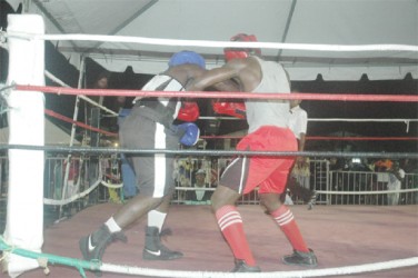 Action between Marvin Ageday (blue) and Williams Hendricks Sunday night. 