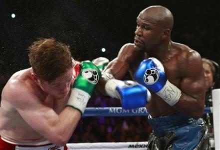 WBC/WBA 154-pound champion Canelo Alvarez (L) takes a punch from Floyd Mayweather Jr. of the U.S. at the MGM Grand Garden Arena in Las Vegas, Nevada, September 14, 2013.
REUTERS/Steve Marcus