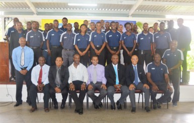 Members of the FIFA Rap Launch Committee sitting from left to right: GFRC Secretary Troy Peters, GFF Vice President Ivan Persaud, GFRC President Alfred King, Minister of Culture Youth and Sport Frank Anthony, GFF President Christopher Matthias, FIFA Referees Instructor Peter Prendergast and FIFA Fitness Instructor Allan Brown while the  participating referees stand at the back.