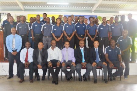 Members of the FIFA Rap Launch Committee sitting from left to right: GFRC Secretary Troy Peters, GFF Vice President Ivan Persaud, GFRC President Alfred King, Minister of Culture Youth and Sport Frank Anthony, GFF President Christopher Matthias, FIFA Referees Instructor Peter Prendergast and FIFA Fitness Instructor Allan Brown while the  participating referees stand at the back.