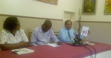 Moses Nagamootoo (right) holds up one of the pamphlets allegedly circulated by the PPP