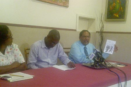 Moses Nagamootoo (right) holds up one of the pamphlets allegedly circulated by the PPP