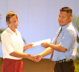 A student from the North West Secondary School receives her SCCP Certificate (GINA photo)