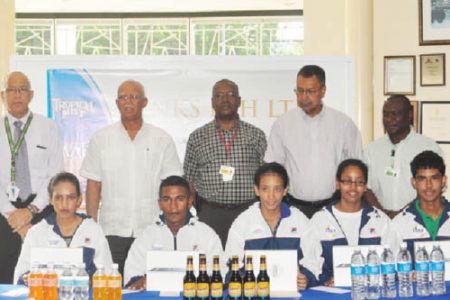 Newly appointed Banks DIH sport ambassadors  (seated from left to right) Christine Sukhram, Neil Reece, Ashley De Groot, Soroya Simmons and Daniel Lopes along with company executives (from left to right) Andrew Carto, Clifford Reis, George McDonald, Michael Pereira and Troy Peters. The sixth ambassador, Stefan Corlette is not in photo. 